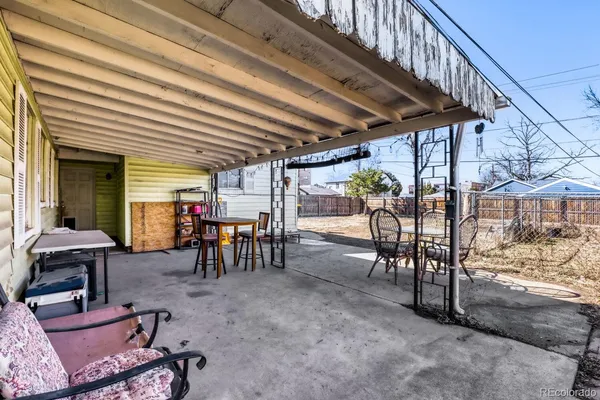 a view of a chairs and table in patio