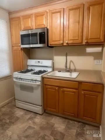 a kitchen with stainless steel appliances granite countertop a sink and a microwave