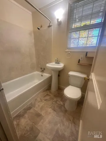 a bathroom with a sink a toilet and bathtub