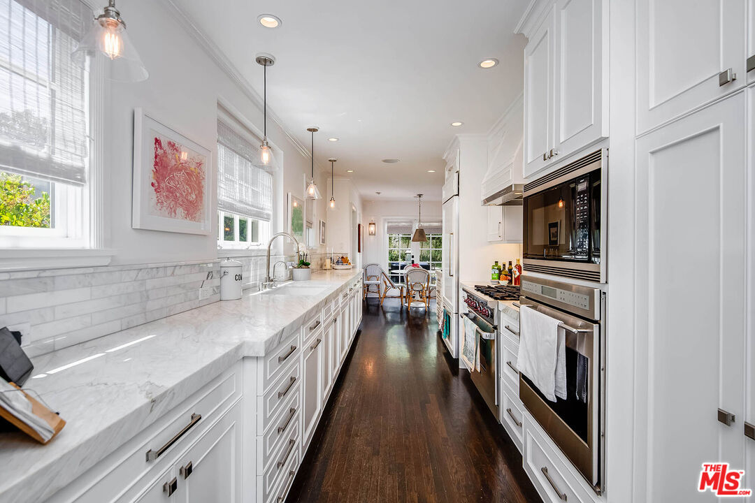 2755 McConnell Drive Los Angeles, CA 90064 - Photo 12 of 47 a kitchen with stainless steel appliances granite countertop a stove and a sink