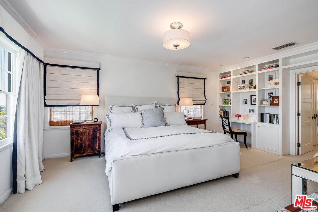 2755 McConnell Drive Los Angeles, CA 90064 - Photo 34 of 47 a bedroom with a bed and a chandelier