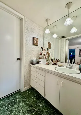 a bathroom with a sink and a mirror