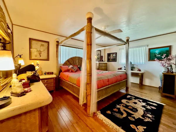 a bedroom with bed and a chandelier