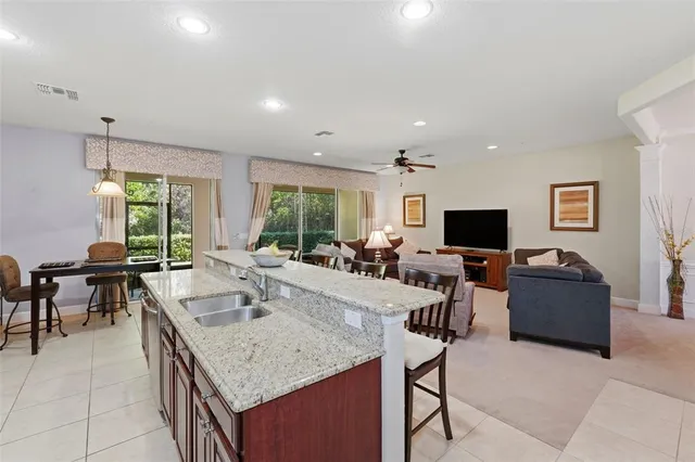 a kitchen with granite countertop stainless steel appliances a sink stove top oven and cabinets