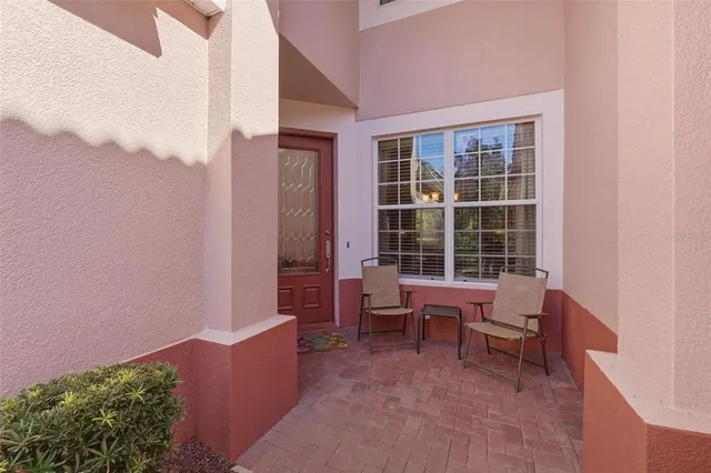 a living room with lots of furniture and a large window