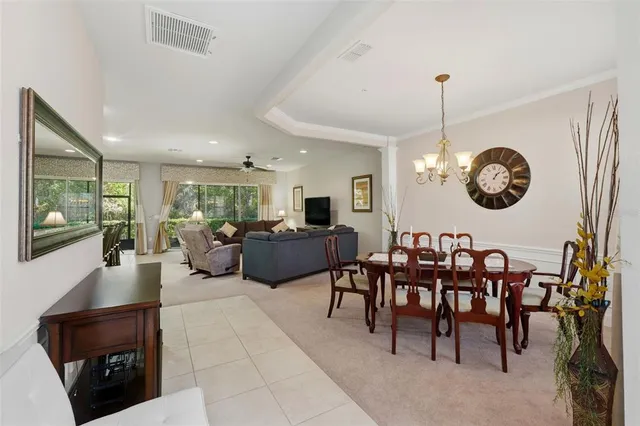 a view of a dining room with furniture and chandelier