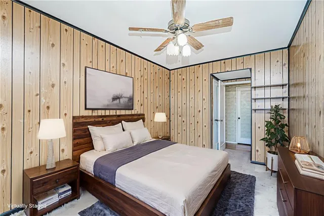 a bedroom with a large bed and a chandelier