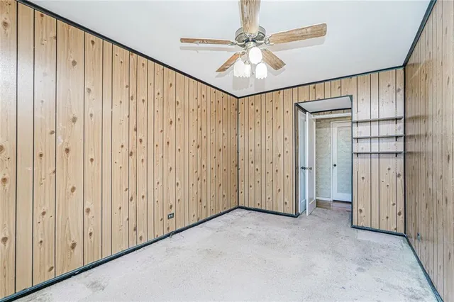 a view of a hallway with a chandelier fan