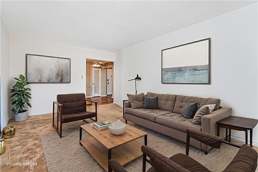 2514 East 7th Street, Unit 6J Brooklyn, NY 11235 - Photo 13 of 17 a living room with furniture and a wooden floor