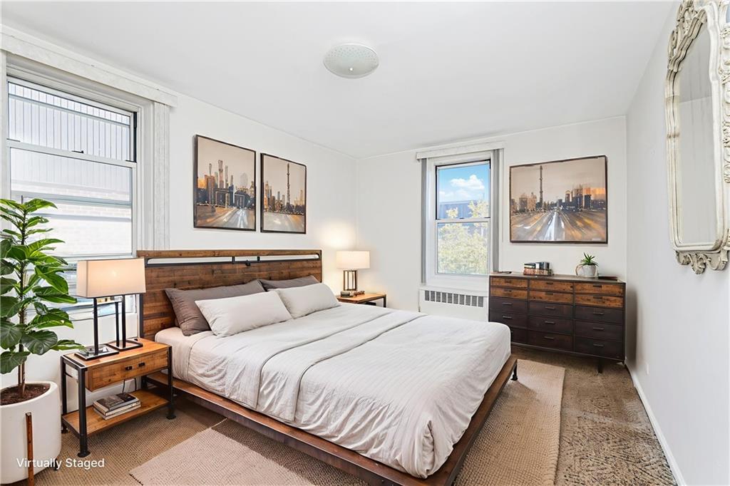 2514 East 7th Street, Unit 6J Brooklyn, NY 11235 - Photo 6 of 17 a bedroom with a bed and a couch