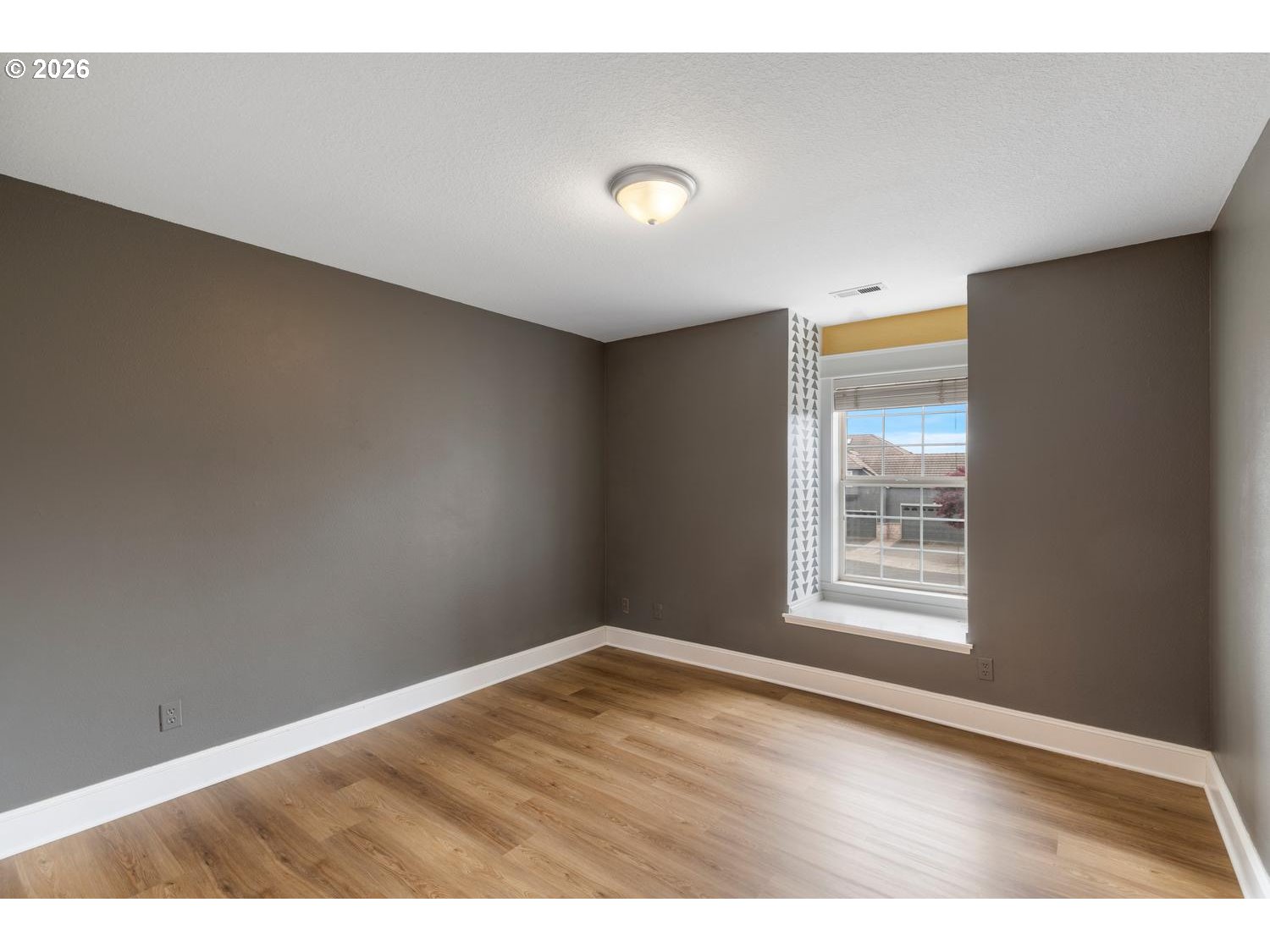 2519 Northwest 24th Circle Camas, WA 98607 - Photo 39 of 48 a view of an empty room with wooden floor and a window
