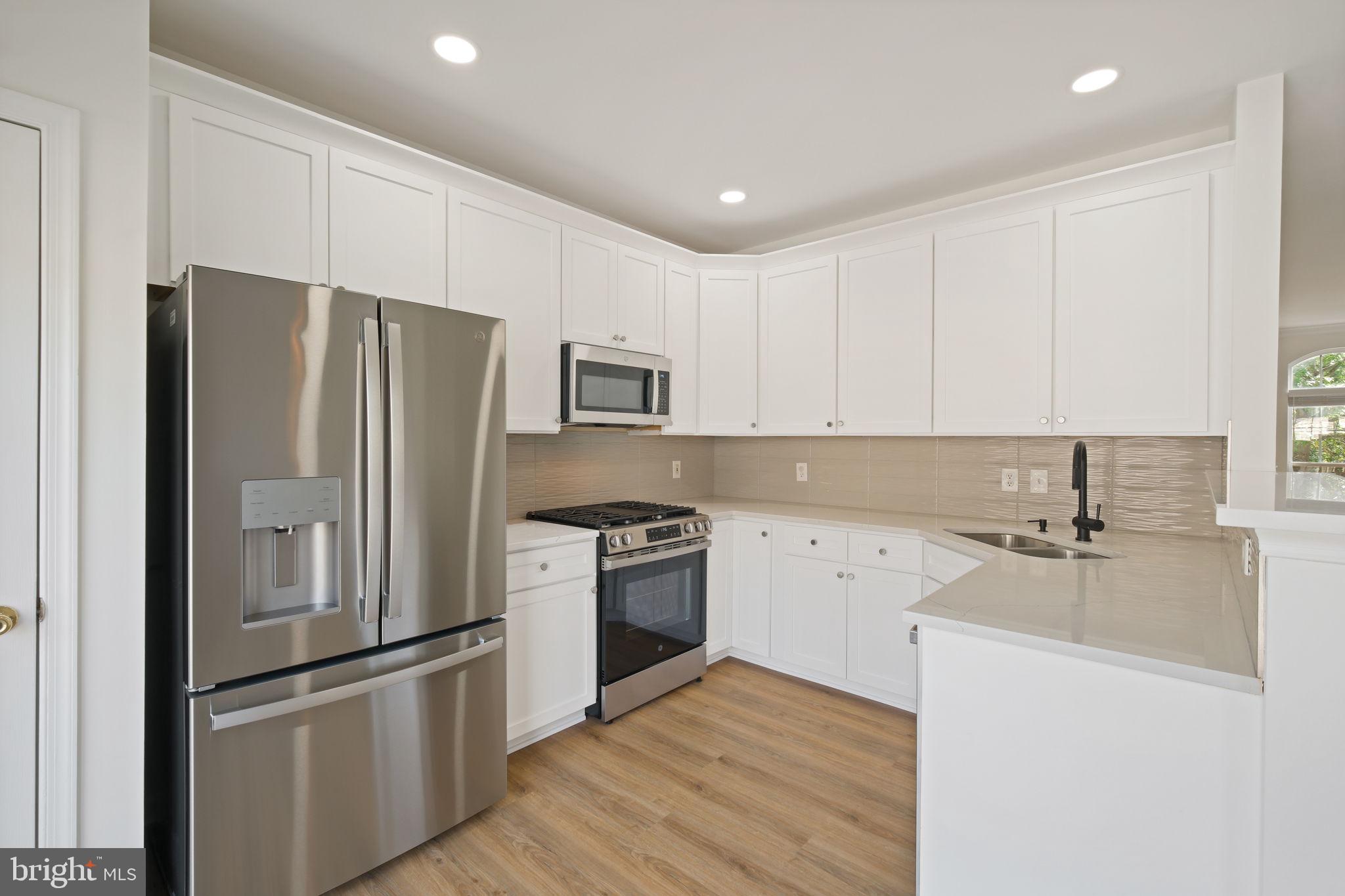 719 Main Street, Unit 719B Gaithersburg, MD 20878 - Photo 12 of 43 a kitchen with cabinets and stainless steel appliances