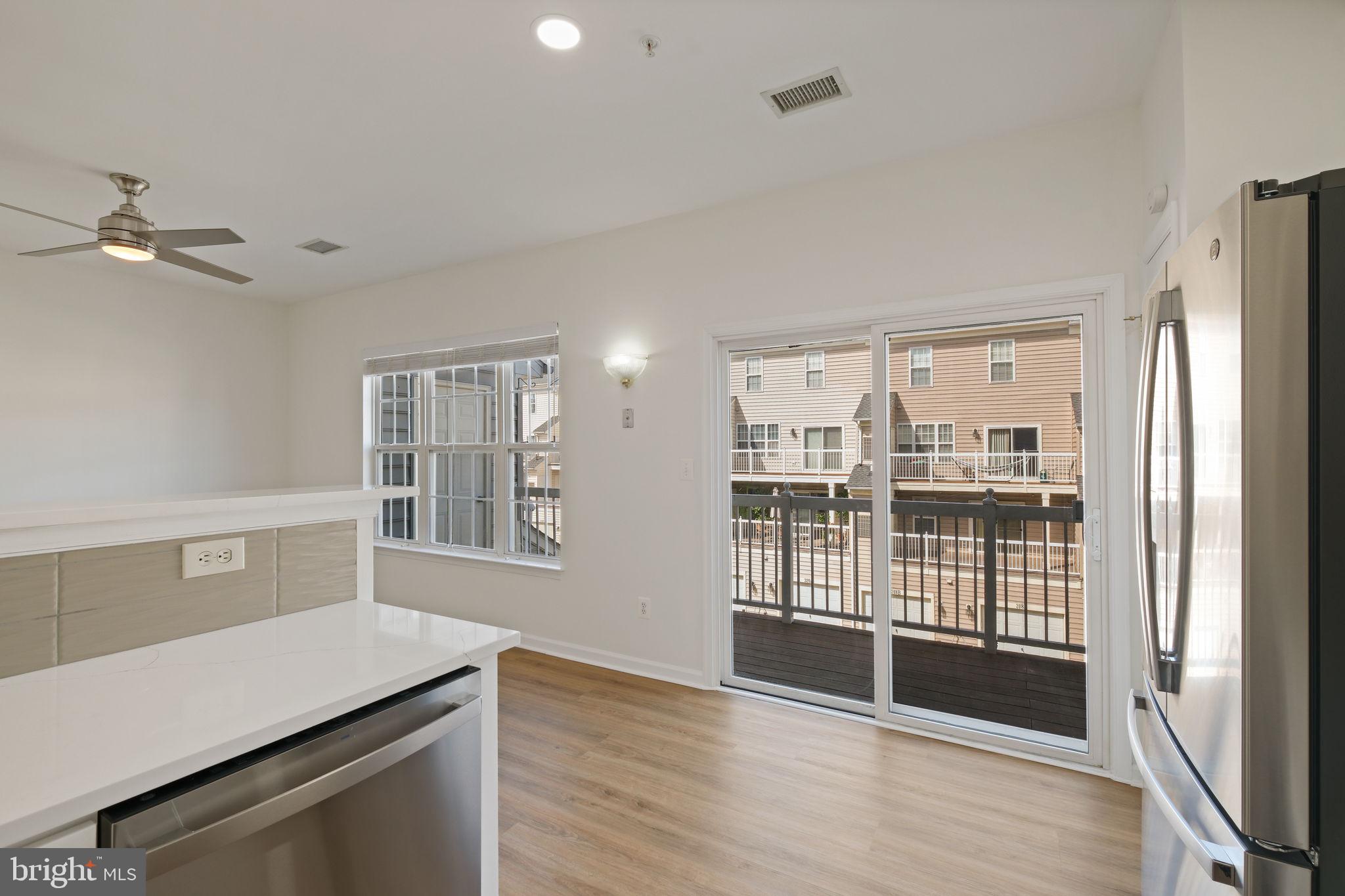 719 Main Street, Unit 719B Gaithersburg, MD 20878 - Photo 14 of 43 a view of a kitchen with fridge and wooden floor