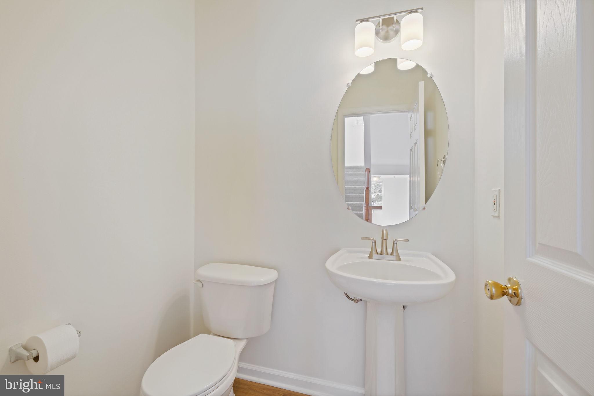 719 Main Street, Unit 719B Gaithersburg, MD 20878 - Photo 15 of 43 a bathroom with a toilet sink and mirror