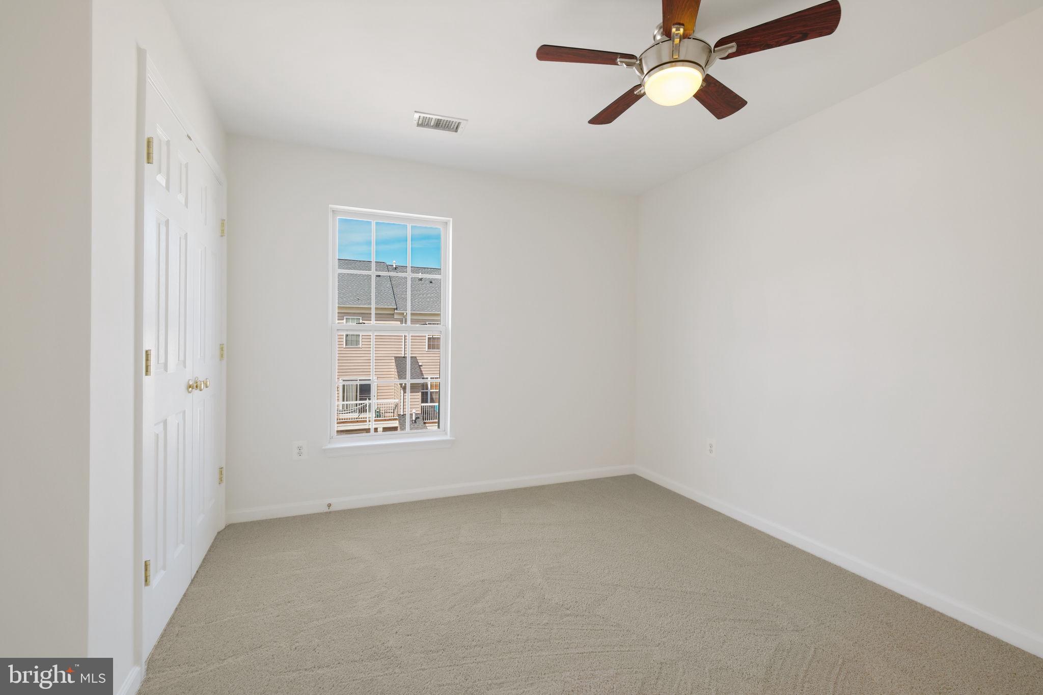 719 Main Street, Unit 719B Gaithersburg, MD 20878 - Photo 22 of 43 an empty room with windows and fan