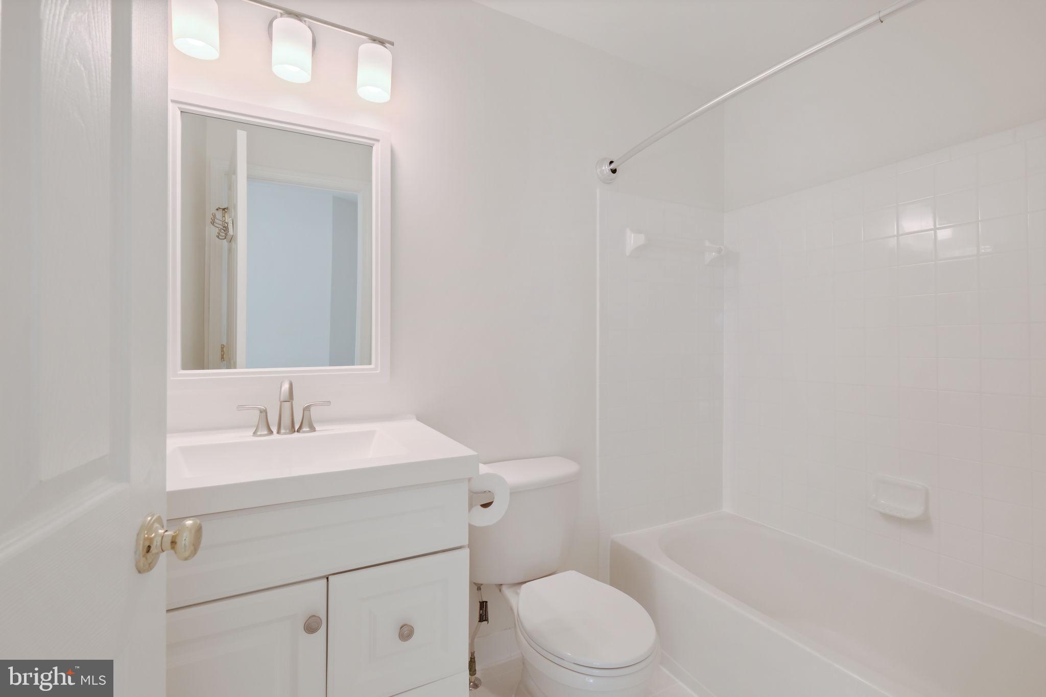 719 Main Street, Unit 719B Gaithersburg, MD 20878 - Photo 23 of 43 a bathroom with a sink a toilet and shower