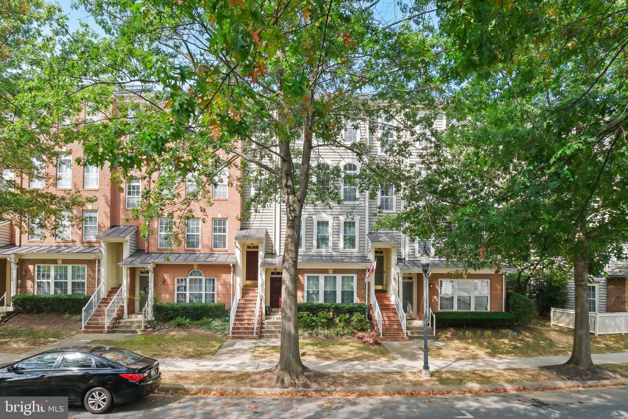 719 Main Street, Unit 719B Gaithersburg, MD 20878 - Photo 3 of 43 a view of a blue house with a tree in front of it