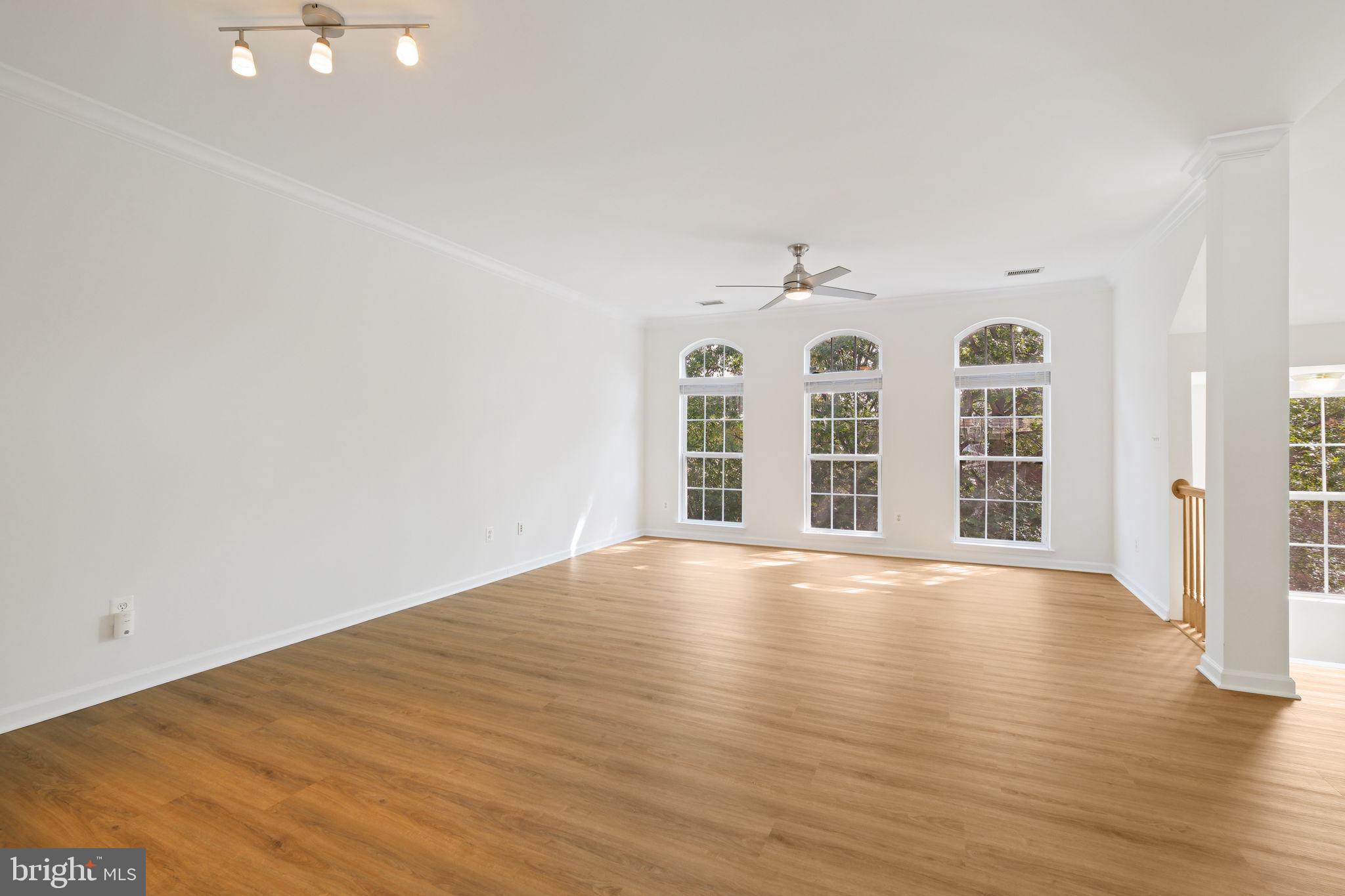 719 Main Street, Unit 719B Gaithersburg, MD 20878 - Photo 6 of 43 an empty room with wooden floor and windows