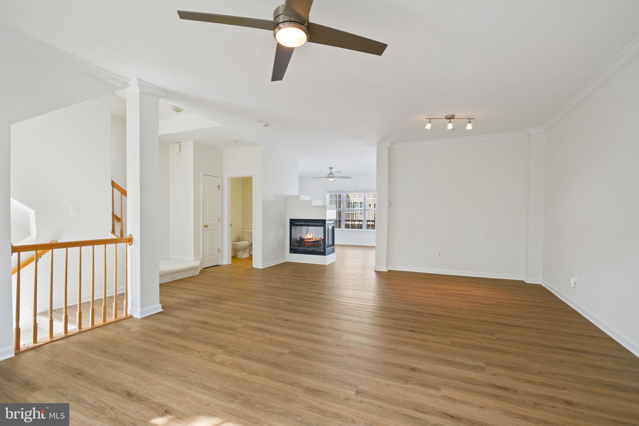 719 Main Street, Unit 719B Gaithersburg, MD 20878 - Photo 7 of 43 a view of empty room with wooden floor and ceiling fan