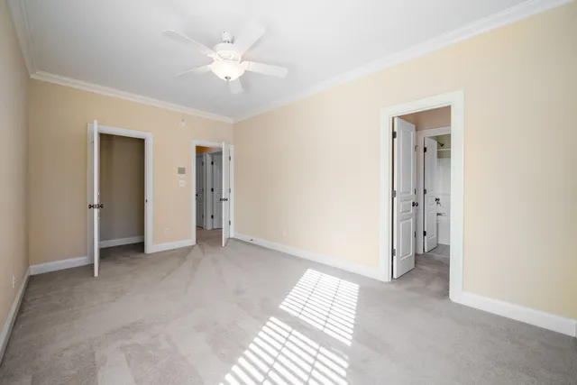 a view of a big room with closet and a ceiling fan