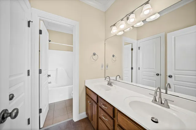 a bathroom with a sink double vanity and shower