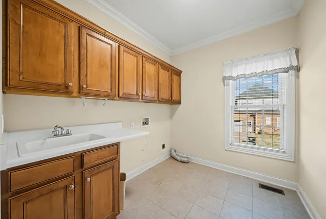 a kitchen with a sink cabinets and a window
