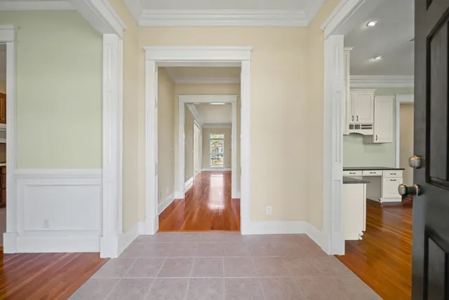 a view of a room with wooden floor and a bathroom