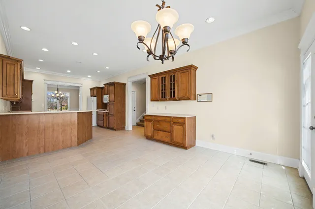 a living room with stainless steel appliances kitchen island granite countertop furniture and a flat screen tv