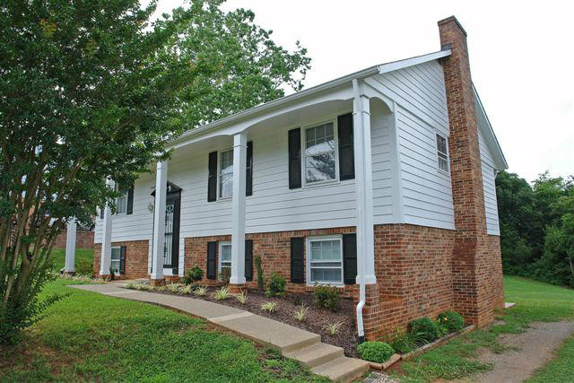 1608 Indian Rock Road Roanoke, VA 24014 - Photo 4 of 37 a front view of a house with a garden and yard