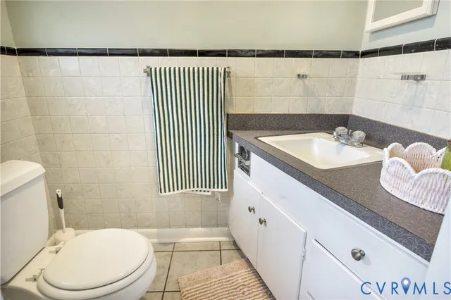 a bathroom with a sink a toilet and a mirror