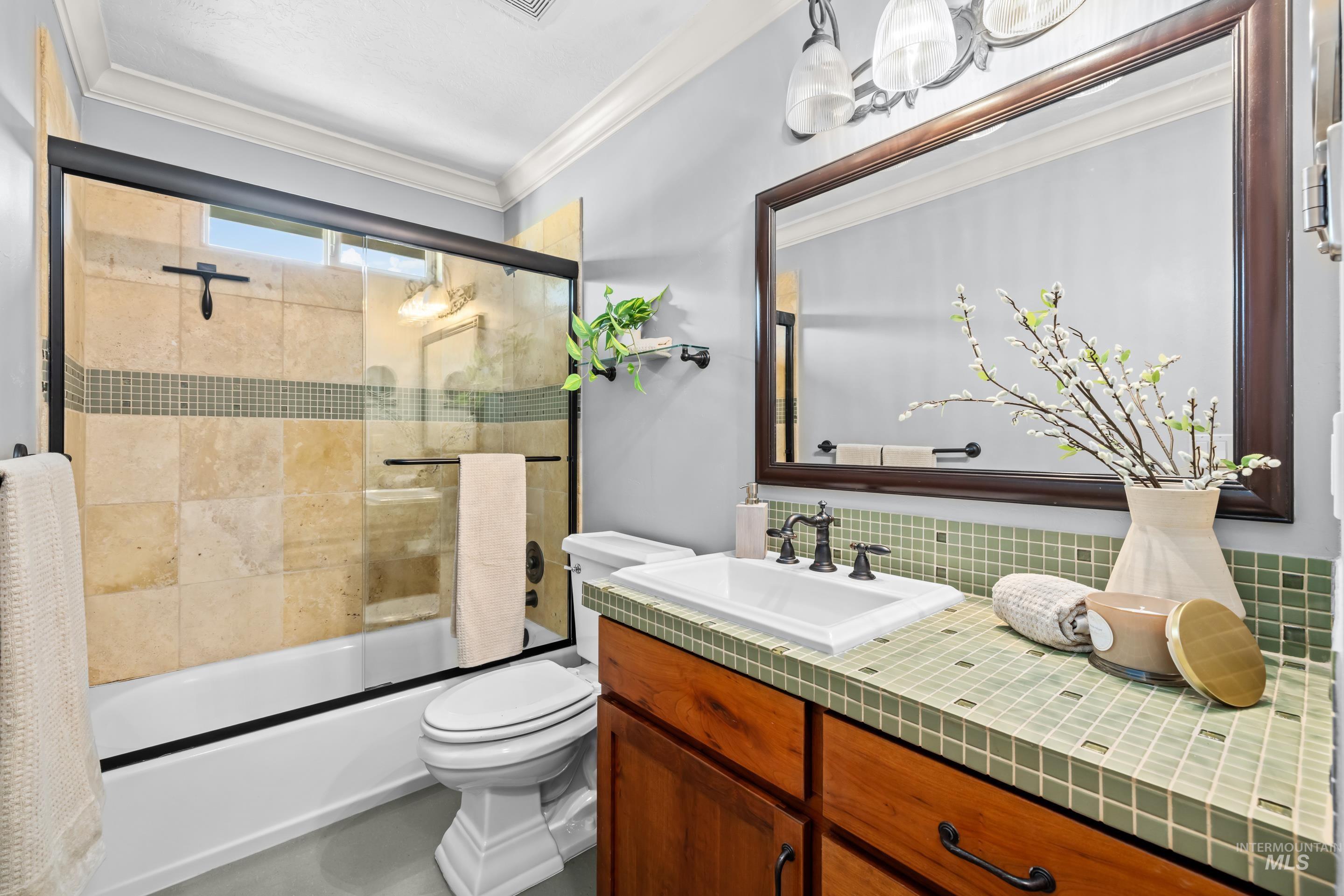 1862 West Ridenbaugh Street Boise, ID 83702 - Photo 32 of 40 Glass-enclosed shower with stone tile surround, integrated window, and a wood-finish vanity with square tile countertop