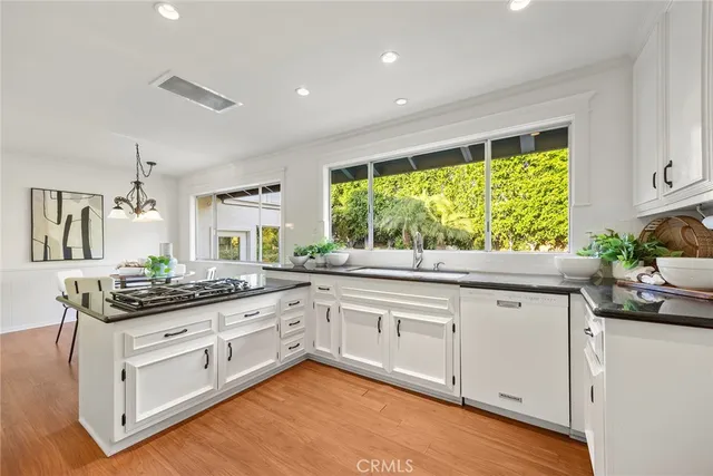 a spacious bathroom with a granite countertop sink a toilet a mirror a vanity and shower