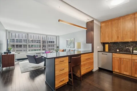 a kitchen with stainless steel appliances granite countertop a stove and cabinets