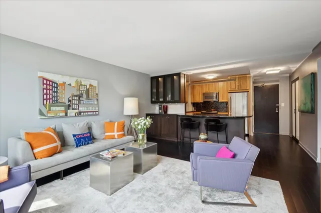 a living room with furniture and a kitchen view