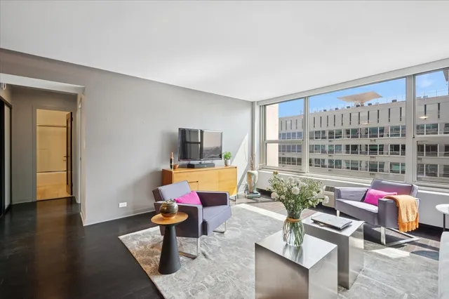 a living room with furniture and floor to ceiling window