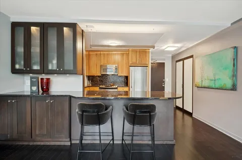 a kitchen with stainless steel appliances granite countertop a stove top oven a sink and cabinets