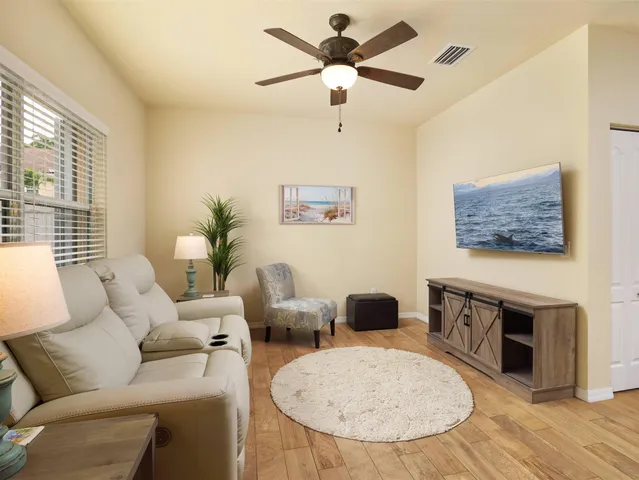 a living room with furniture a fireplace with wooden floor