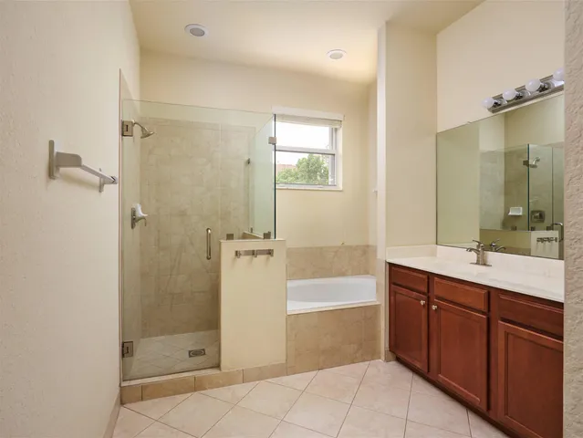 a spacious bathroom with a shower sink and mirror