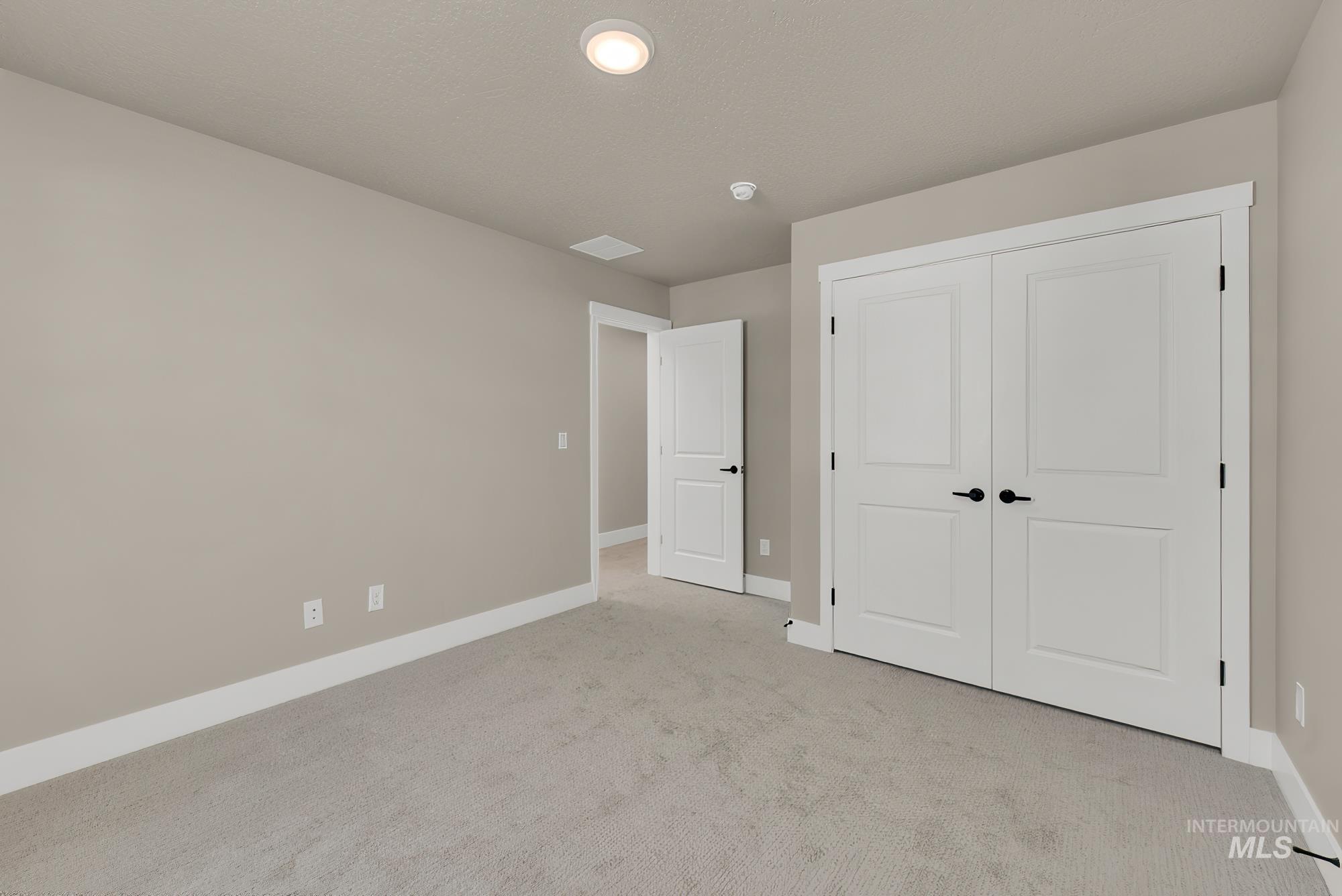 2807 West Jutland Street Meridian, ID 83642 - Photo 12 of 25 Unfurnished bedroom featuring carpet flooring and a closet