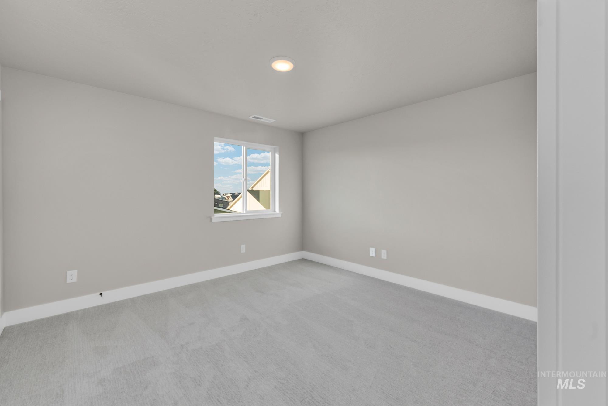 2807 West Jutland Street Meridian, ID 83642 - Photo 18 of 25 Empty room featuring light colored carpet and recessed lighting