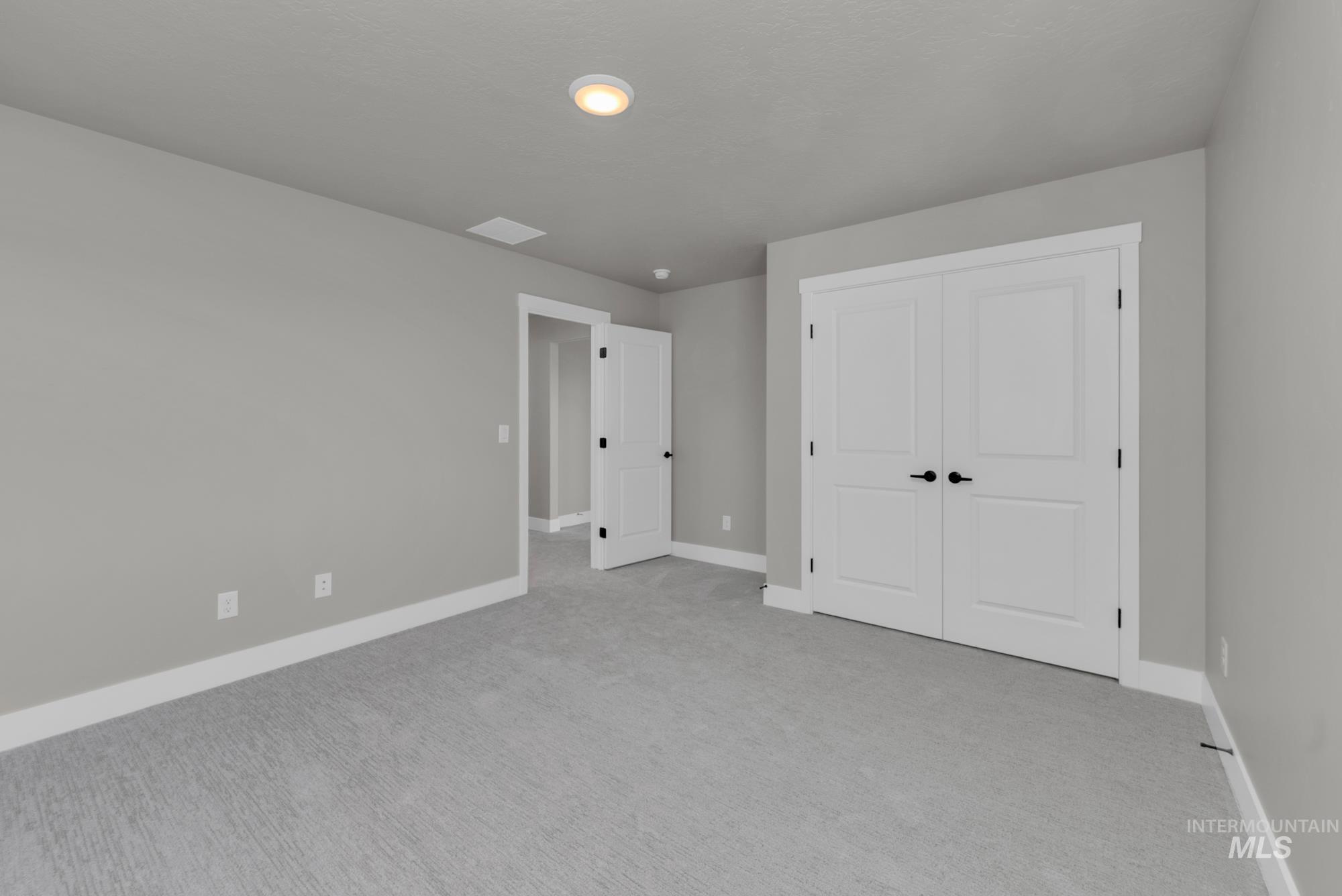 2807 West Jutland Street Meridian, ID 83642 - Photo 19 of 25 Unfurnished bedroom with light colored carpet and a closet