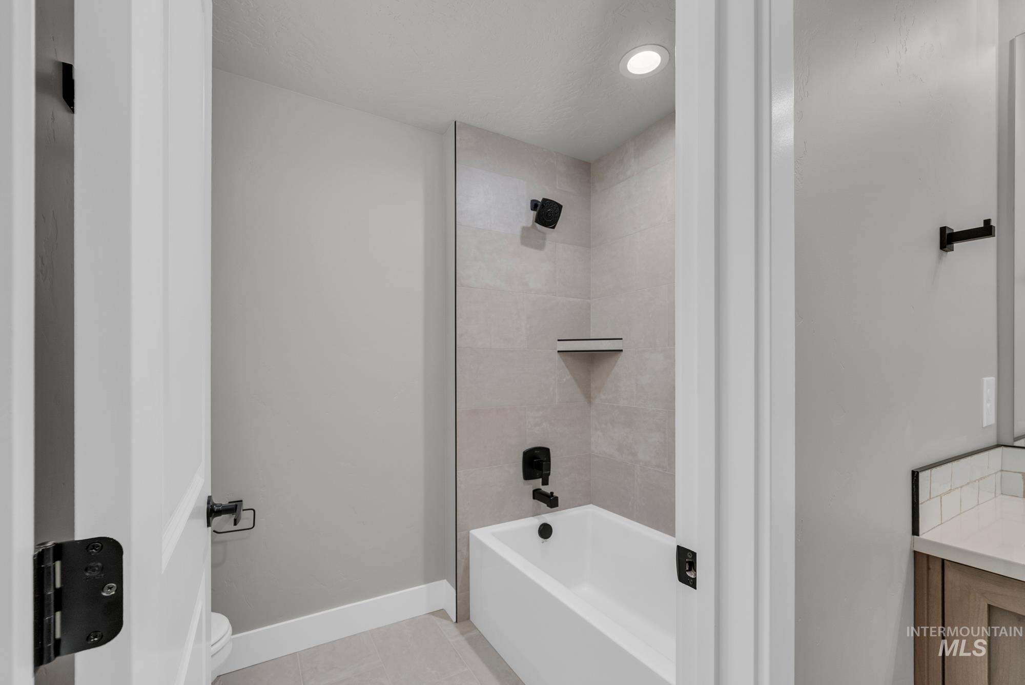 2807 West Jutland Street Meridian, ID 83642 - Photo 20 of 25 Bathroom featuring shower combination and light tile patterned flooring