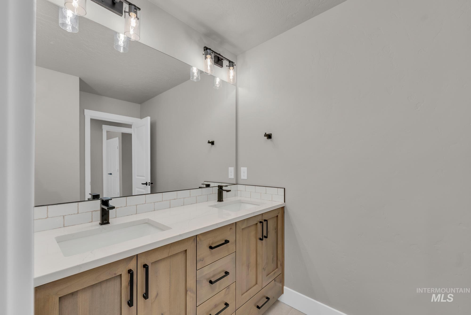 2807 West Jutland Street Meridian, ID 83642 - Photo 21 of 25 Bathroom featuring double vanity and baseboards