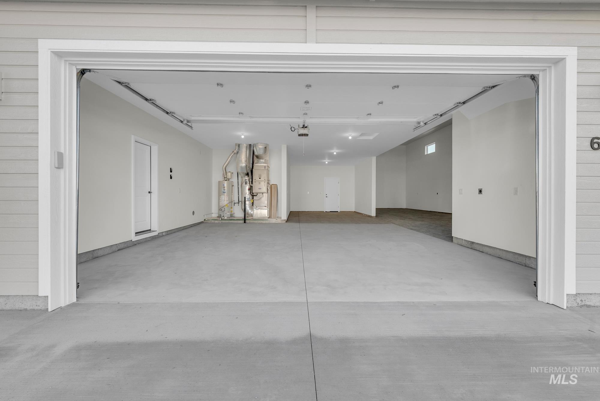 2807 West Jutland Street Meridian, ID 83642 - Photo 24 of 25 Garage with secured water heater, wood walls, and heating unit