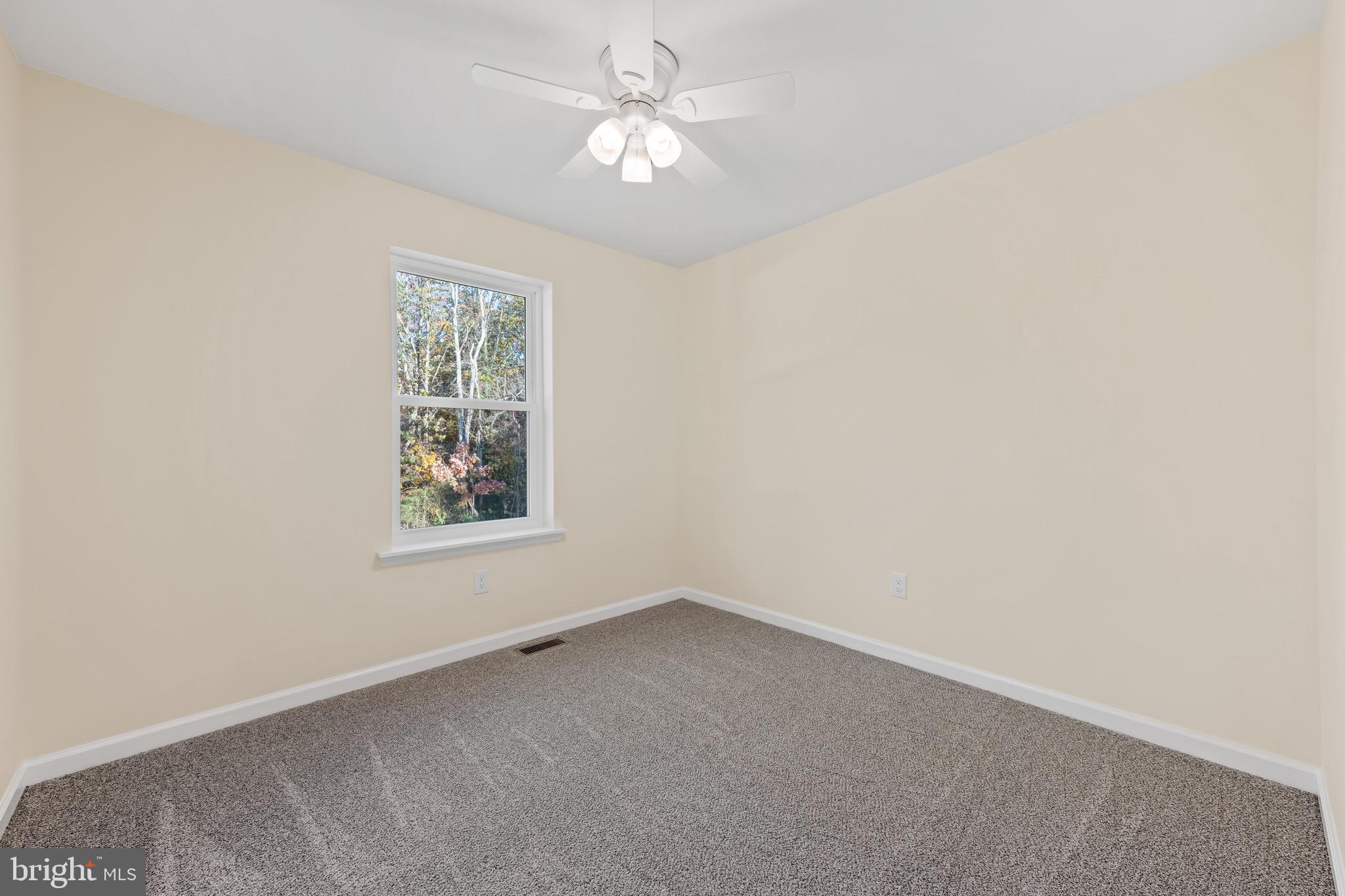 1488 North Tuckahoe Road Williamstown, NJ 08094 - Photo 12 of 27 an empty room with a window and a fan