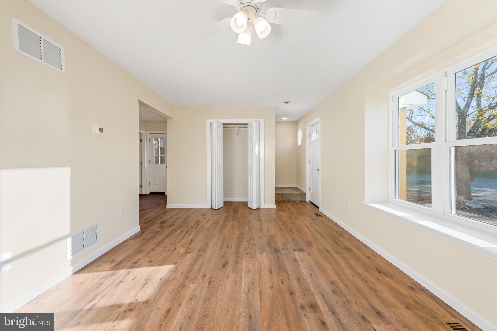 1488 North Tuckahoe Road Williamstown, NJ 08094 - Photo 4 of 27 a view of an empty room with wooden floor and a window