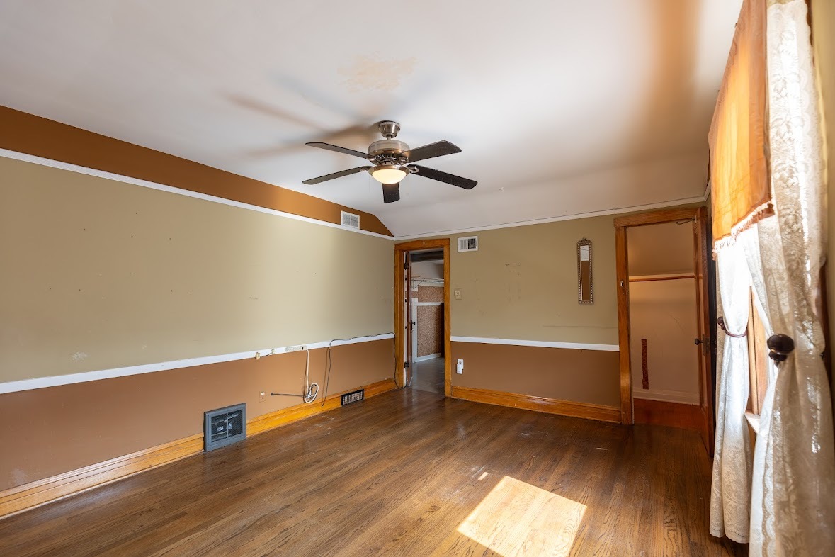 6840 29th Place Berwyn, IL 60402 - Photo 21 of 32 a view of room with wooden floor and fan