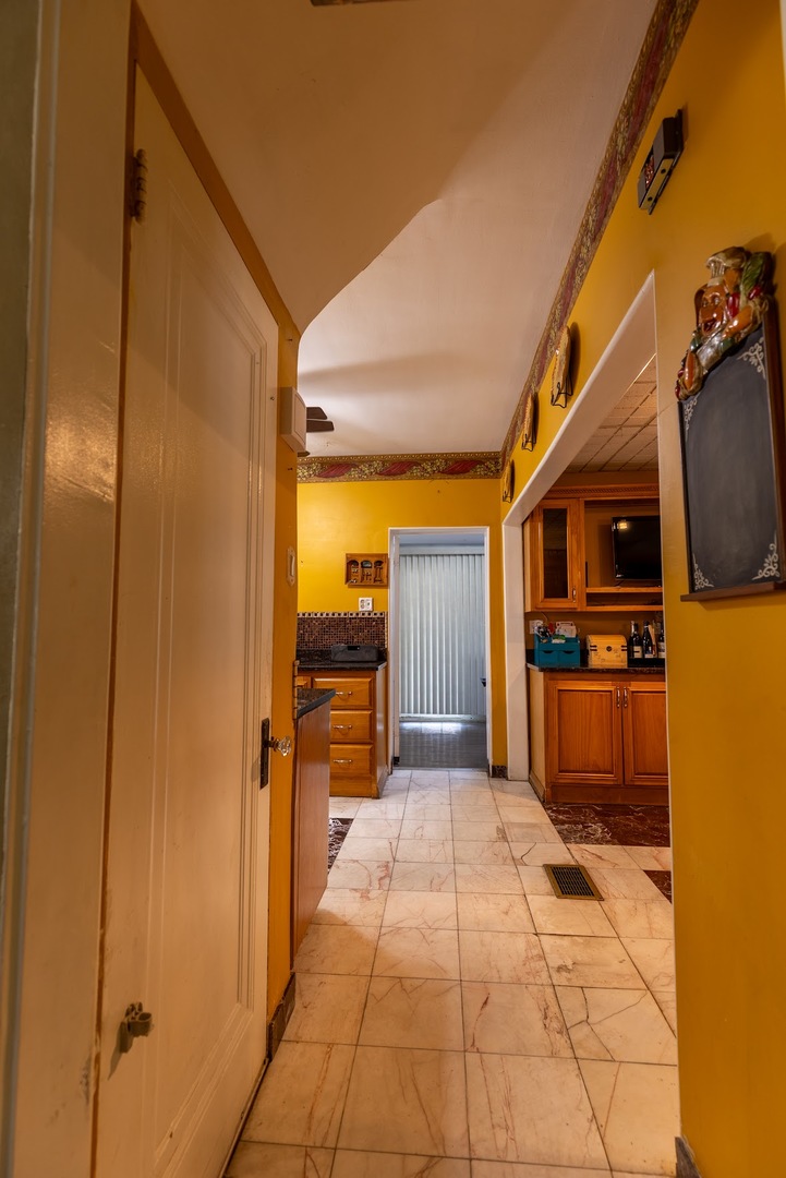 6840 29th Place Berwyn, IL 60402 - Photo 7 of 32 a view of a hallway with a refrigerator and a stove