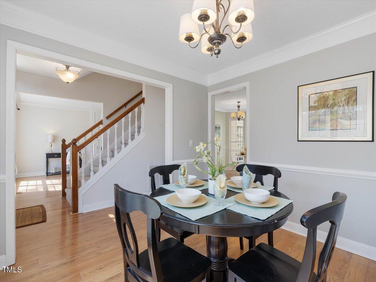 4818 Glendarion Drive Durham, NC 27713 - Photo 10 of 44 a view of a dining room with furniture and wooden floor