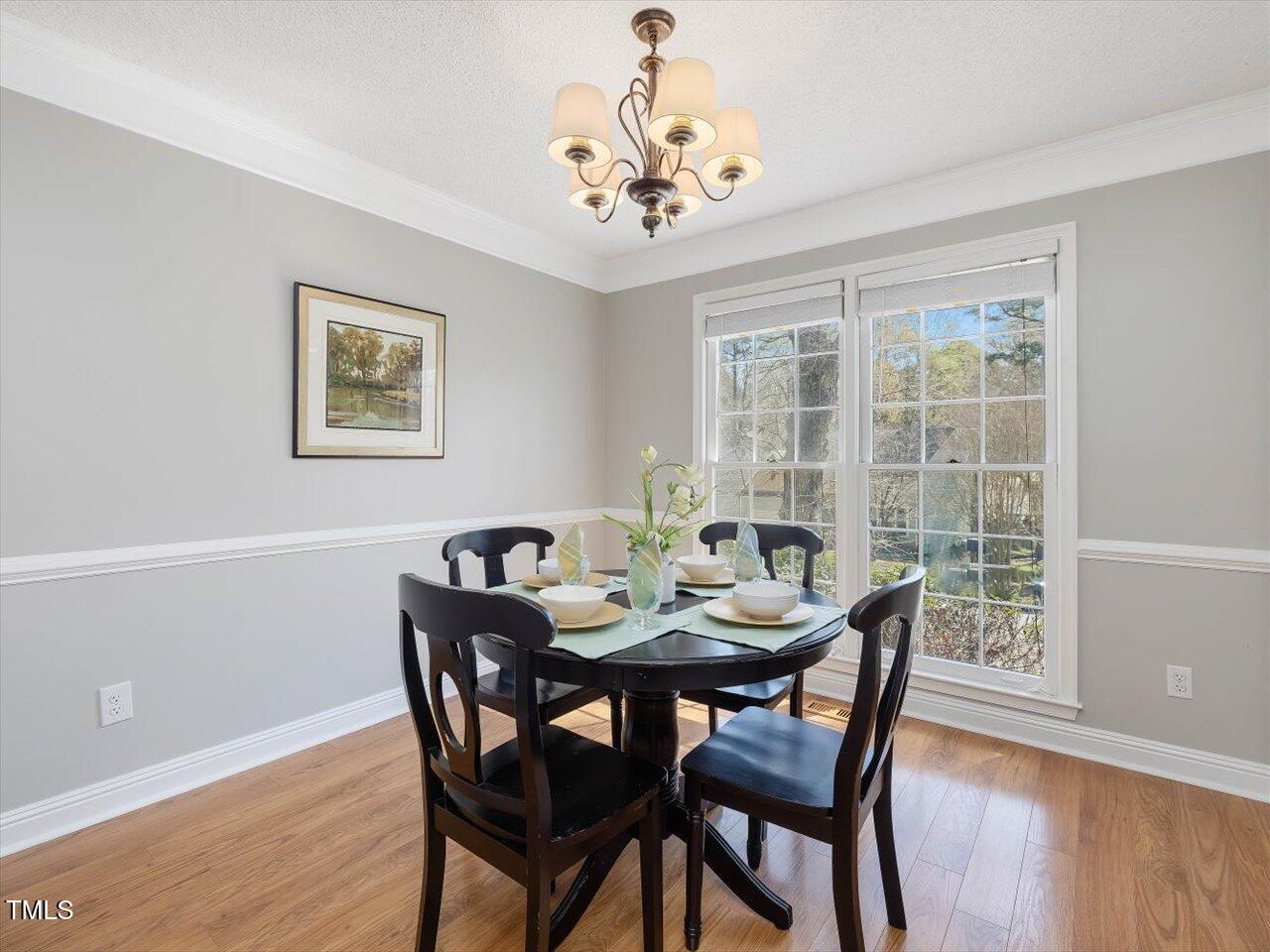 4818 Glendarion Drive Durham, NC 27713 - Photo 11 of 44 a view of a dining room with furniture window and wooden floor